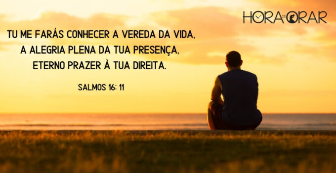 Homem sentado no por do sol.